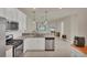 Eat-in kitchen featuring stainless steel appliances, granite countertops and open to the living area at 9916 Bright Water Dr, Englewood, FL 34223