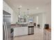 Kitchen showcasing stainless steel appliances, granite counters and open to the living room at 9916 Bright Water Dr, Englewood, FL 34223