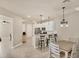 Bright kitchen open to dining area, featuring stainless steel appliances and a breakfast bar at 9916 Bright Water Dr, Englewood, FL 34223