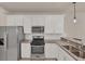 Bright kitchen with stainless steel appliances and granite counters with breakfast bar seating at 9916 Bright Water Dr, Englewood, FL 34223