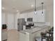 Eat-in kitchen featuring stainless steel appliances, granite countertops and breakfast bar seating at 9916 Bright Water Dr, Englewood, FL 34223