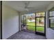Screened lanai with brick flooring and a relaxing view of the landscaped backyard at 9916 Bright Water Dr, Englewood, FL 34223
