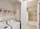 Efficient laundry room featuring modern appliances and ample storage shelving at 9916 Bright Water Dr, Englewood, FL 34223