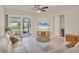 Inviting living room with modern furnishings, tile flooring, and a seamless transition to the outdoors at 9916 Bright Water Dr, Englewood, FL 34223