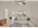 Cozy living room with a comfortable sofa, open floor plan, and modern light fixtures at 9916 Bright Water Dr, Englewood, FL 34223