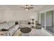 Inviting living room with comfortable seating, neutral décor, and sliding glass doors to the outdoors at 9916 Bright Water Dr, Englewood, FL 34223