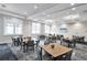 Large meeting room filled with tables, chairs, and bright windows at 9916 Bright Water Dr, Englewood, FL 34223