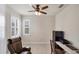 Bright office space with a ceiling fan, plantation shutters, desk, and comfortable chair at 9916 Bright Water Dr, Englewood, FL 34223