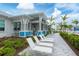 Beautifully landscaped pool area with lounge chairs and a covered pavilion on a sunny day at 9916 Bright Water Dr, Englewood, FL 34223