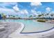 Large resort-style pool with zero entry and plenty of lounging chairs at 9916 Bright Water Dr, Englewood, FL 34223