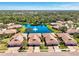 Wonderful aerial view of the villa community surrounding a lake with mature trees and fountain at 1018 Yosemite Dr, Englewood, FL 34223