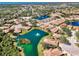 Gorgeous aerial view of the community featuring mature trees, multiple serene ponds with fountains, and neighborhood homes at 1018 Yosemite Dr, Englewood, FL 34223