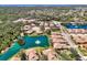 Beautiful aerial view of the community's lush landscaping, serene pond with fountain, and well-maintained homes at 1018 Yosemite Dr, Englewood, FL 34223