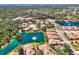 Beautiful aerial view of the community's lush landscaping, serene pond with fountain, and well-maintained homes at 1018 Yosemite Dr, Englewood, FL 34223