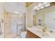 Clean bathroom featuring tiled shower with gold-tone trim and a single sink vanity with storage at 1018 Yosemite Dr, Englewood, FL 34223
