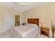 Bedroom featuring neutral color palette, comfortable bed, and easy access to a full bathroom at 1018 Yosemite Dr, Englewood, FL 34223