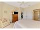 Bedroom showcasing neutral color palette, comfortable bed, and easy access to a full bathroom at 1018 Yosemite Dr, Englewood, FL 34223