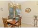 Charming dining room featuring a wooden table with seating for four and a window bringing natural light at 1018 Yosemite Dr, Englewood, FL 34223
