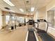 Well-equipped fitness center with treadmills, weight machines, and natural light streaming through large windows at 1018 Yosemite Dr, Englewood, FL 34223