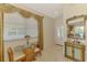 Inviting foyer with decorative mirror, table, and a view of the front door and dining space at 1018 Yosemite Dr, Englewood, FL 34223