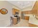 Bright kitchen with wood cabinetry, stainless steel appliances, tiled floors, and ample counter space at 1018 Yosemite Dr, Englewood, FL 34223