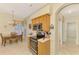Eat-in kitchen with stainless appliances, oak cabinetry, breakfast nook, and access to hallway at 1018 Yosemite Dr, Englewood, FL 34223