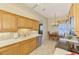 Bright kitchen featuring oak cabinets, white countertops, stainless steel appliances, and tile flooring at 1018 Yosemite Dr, Englewood, FL 34223