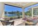 Relax on this screened lanai overlooking a pond with fountain; it features tile flooring and comfortable seating at 1018 Yosemite Dr, Englewood, FL 34223