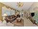 Comfortable living room with leather furniture, neutral tile flooring, and a large window view, light and airy at 1018 Yosemite Dr, Englewood, FL 34223