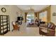 Inviting living room with a large leather sofa, view of water, neutral tile floors, and decorative window treatments at 1018 Yosemite Dr, Englewood, FL 34223