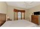 Spacious main bedroom featuring neutral color palette, bay windows, and comfortable furnishings at 1018 Yosemite Dr, Englewood, FL 34223