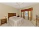Calm main bedroom with a large bed, bay windows offering a lake view, and neutral decor at 1018 Yosemite Dr, Englewood, FL 34223