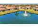 Scenic pond view with a fountain, adjacent to lovely homes and well-maintained lawn at 1018 Yosemite Dr, Englewood, FL 34223