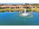 Scenic pond view with a fountain, adjacent to lovely home with large windows and outdoor space at 1018 Yosemite Dr, Englewood, FL 34223