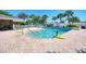 A beautiful outdoor pool with crystal-clear water awaits you, surrounded by comfortable lounge seating at 1018 Yosemite Dr, Englewood, FL 34223