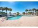 This outdoor pool with a brick surround is perfect for relaxation and fun, set amongst a tropical landscape at 1018 Yosemite Dr, Englewood, FL 34223