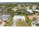 Birds eye view of a single-story home with a white roof, spacious yard, and neighborhood with mature trees at 107 Corot Dr, Nokomis, FL 34275
