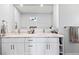 Modern bathroom with marble countertops, dual sinks, and white cabinetry at 107 Corot Dr, Nokomis, FL 34275