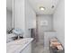 Bathroom with a marble countertop, built-in shelving, and a walk-in shower at 107 Corot Dr, Nokomis, FL 34275