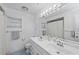 Bright bathroom featuring a double sink vanity, medicine cabinet, and light blue tile flooring at 107 Corot Dr, Nokomis, FL 34275