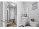 Cozy bathroom with updated sink and fixtures, and a view of the entryway and laundry room at 107 Corot Dr, Nokomis, FL 34275
