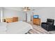 Bright bedroom features a ceiling fan, luxury vinyl plank flooring, and an adjoining bathroom at 107 Corot Dr, Nokomis, FL 34275