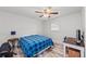 Bedroom featuring a ceiling fan, wooden floors and a large window providing natural light at 107 Corot Dr, Nokomis, FL 34275