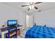 Bedroom featuring a ceiling fan, wooden floors, and a computer desk with a monitor at 107 Corot Dr, Nokomis, FL 34275