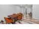 Dining area features a rustic wood table, stylish chairs, and a view of the front entrance at 107 Corot Dr, Nokomis, FL 34275