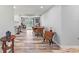Open dining area with wood-look floors, a dining table, and a view of the outdoor patio at 107 Corot Dr, Nokomis, FL 34275
