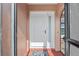 Bright white front door with sidelight, red-tiled porch, and colorful welcome mat at 107 Corot Dr, Nokomis, FL 34275