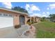 View of the front of the house, with a two-car garage, walkway, and well-maintained landscaping at 107 Corot Dr, Nokomis, FL 34275