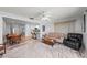 Bright living room boasts a ceiling fan, neutral walls, and seamless flow into the dining area and kitchen at 107 Corot Dr, Nokomis, FL 34275