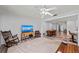 Cozy living room with a large screen TV and a view into the dining area and kitchen at 107 Corot Dr, Nokomis, FL 34275